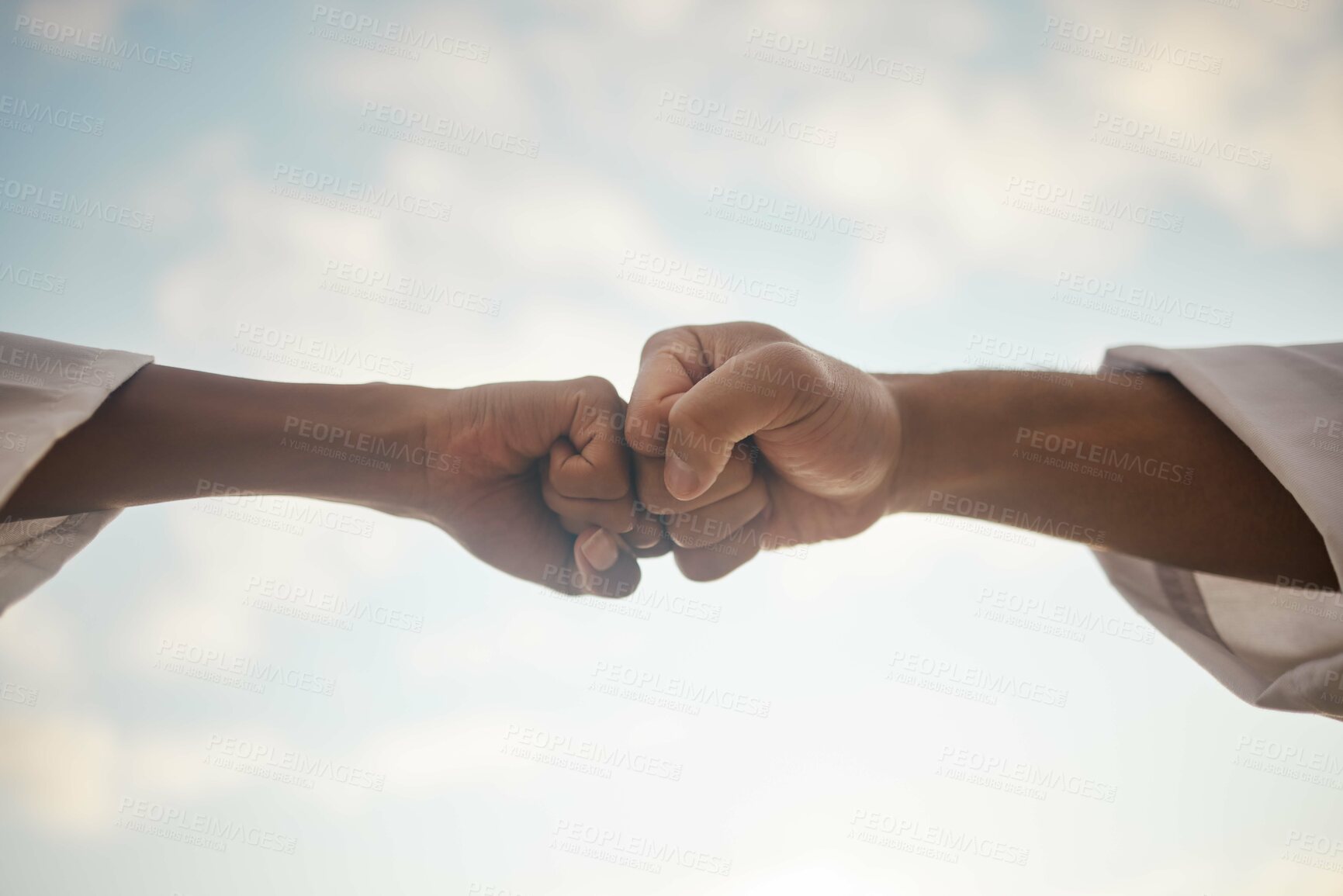 Buy stock photo People, karate and fist bump with sky below for unity, teamwork or outdoor competition in self defense. Low angle of opposing sides touching hands to accept challenge or taekwondo battle in nature