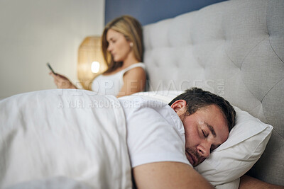 Buy stock photo Couple, sleeping and bed with phone for cheating affair, toxic marriage or argument at home. Young man, asleep or seperation with woman on mobile smartphone for dispute, conflict or betrayal at house