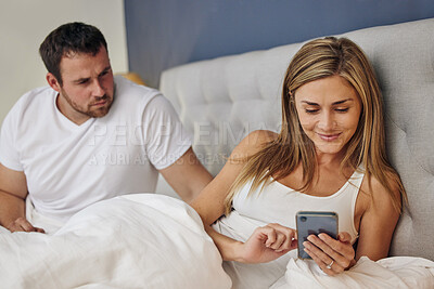 Buy stock photo Phone, bed and woman with angry husband for cheating, infidelity or affair communication online at home. Marriage conflict, argument and happy female person on cellphone app with upset man in bedroom