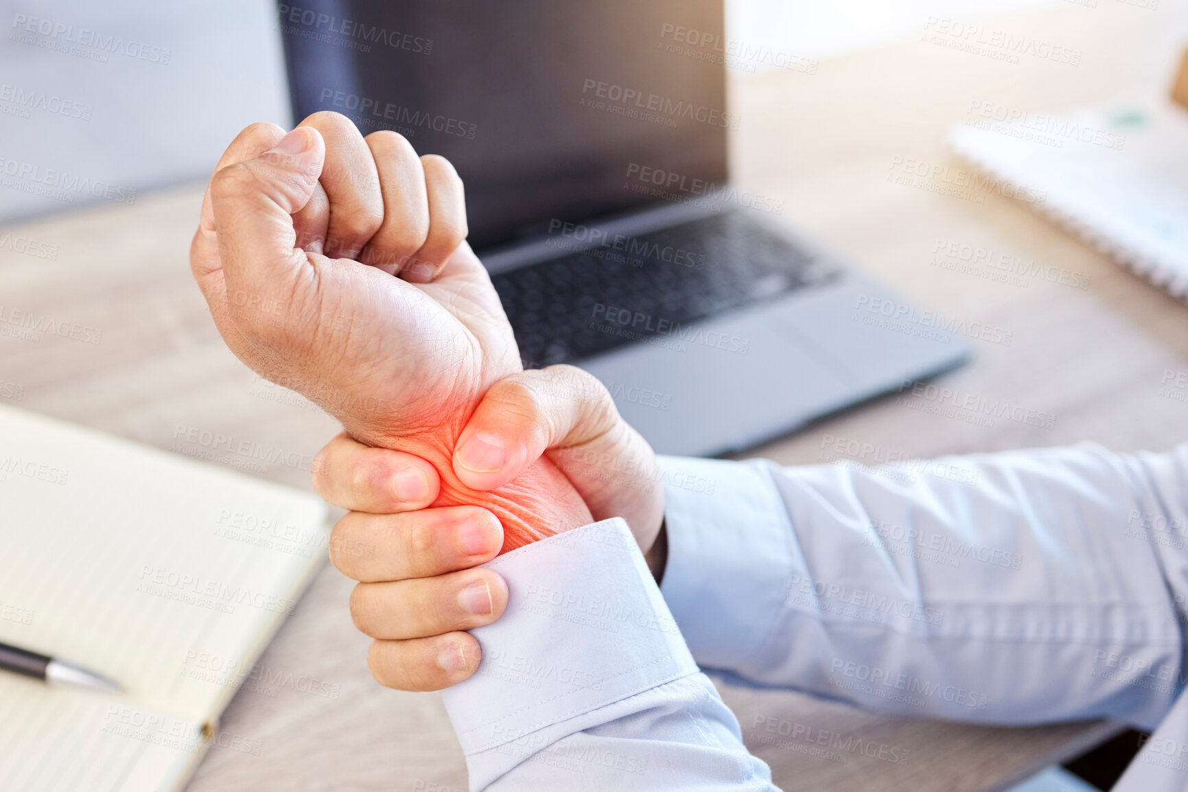 Buy stock photo Arthritis, injury or wrist pain with business man at desk in office with laptop and glowing overlay. Accident, anatomy and burnout with red highlight on arm of employee in workplace for strain