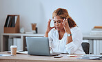 Stressed African American businesswoman making a mistake while using her laptop in the office. Professional black woman feeling pressured while using technology. Creative entrepreneur with a headache