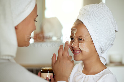 Buy stock photo Fresh skincare, face cream and healthy skin product for mother and daughter home spa day. Fun, smiling and playful child and a parent applying moisturizer for grooming routine or sunscreen protection