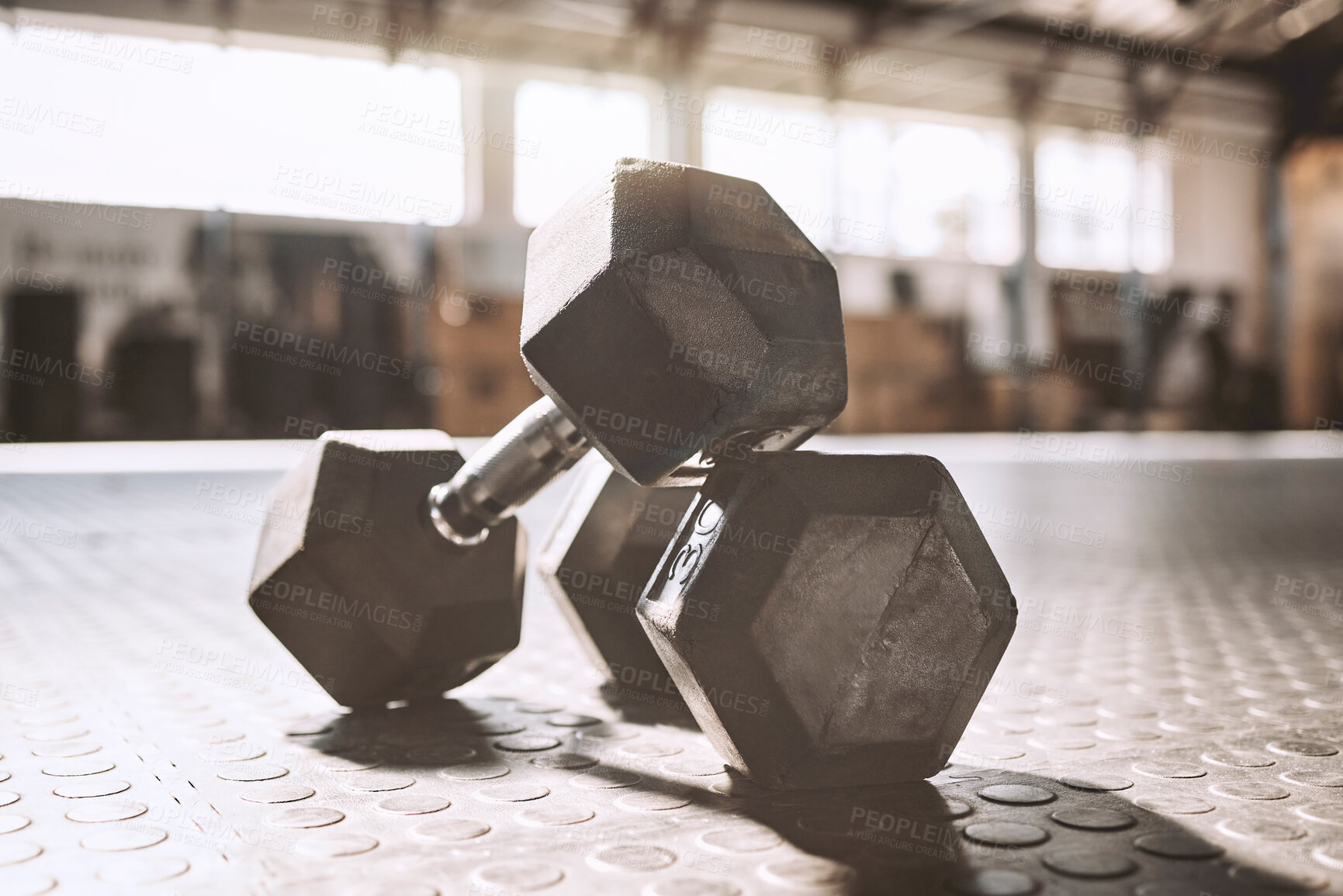 Buy stock photo Fitness, exercise and dumbbell at gym for weight training, health and workout at empty sports center with mockup. Metal, equipment and bodybuilding strength for cardio, wellness and weightlifting