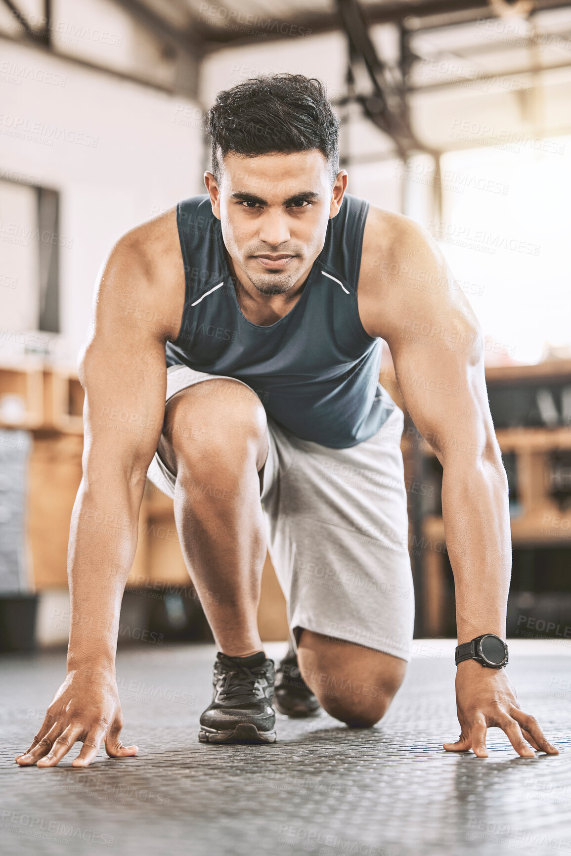 Buy stock photo Fitness, portrait and man ready to start training, exercise and running at sport gym for body health. Determined, crouch and athlete prepare for workout, race and physical challenge with confidence