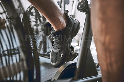 Buy stock photo Bicycle, feet and person with fitness in gym for exercise, cardio or health workout activity. Wellness, cycling and legs of male athlete on electronic bike for training on equipment in sports center.