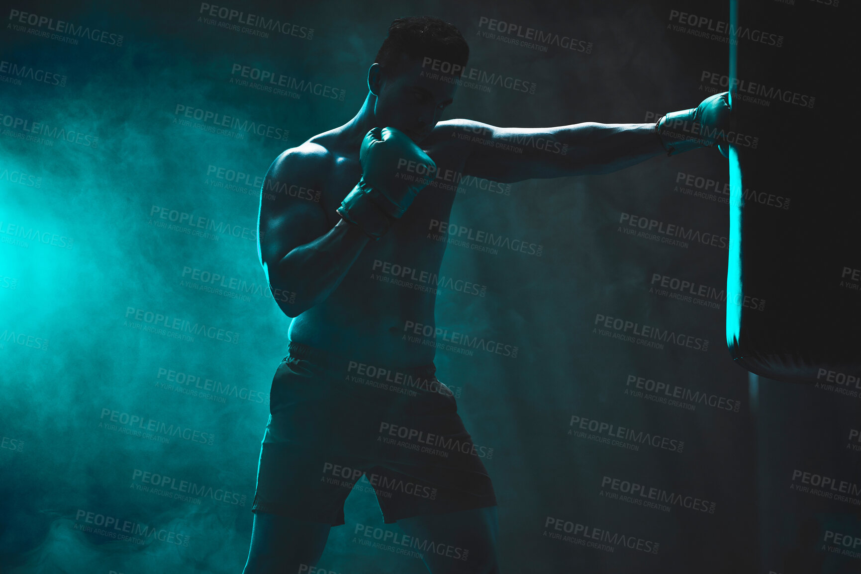 Buy stock photo Man, punching bag and power exercise at gym, training practice and attack challenge for combat. Male person, neon and dojo club aesthetic for boxing competition, athlete and martial arts workout