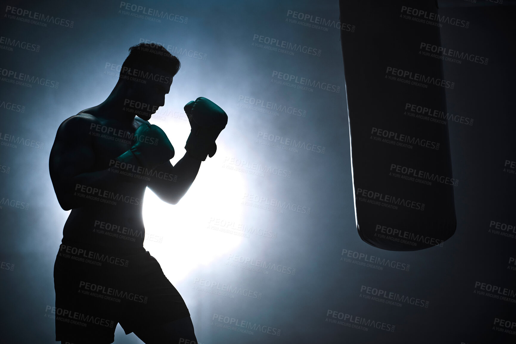 Buy stock photo Man, punching bag and silhouette strong at gym, training practice and attack challenge for combat. Male person, smoke and dojo club aesthetic for boxing competition, athlete and martial arts workout