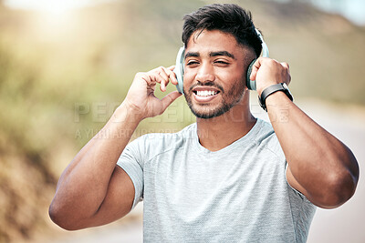 Buy stock photo Headphones, happy and man with smile, fitness and proud of muscle, outdoor and runner in nature for exercise. Confident, sporty and wellness of athlete with workout, audio and music of healthy person