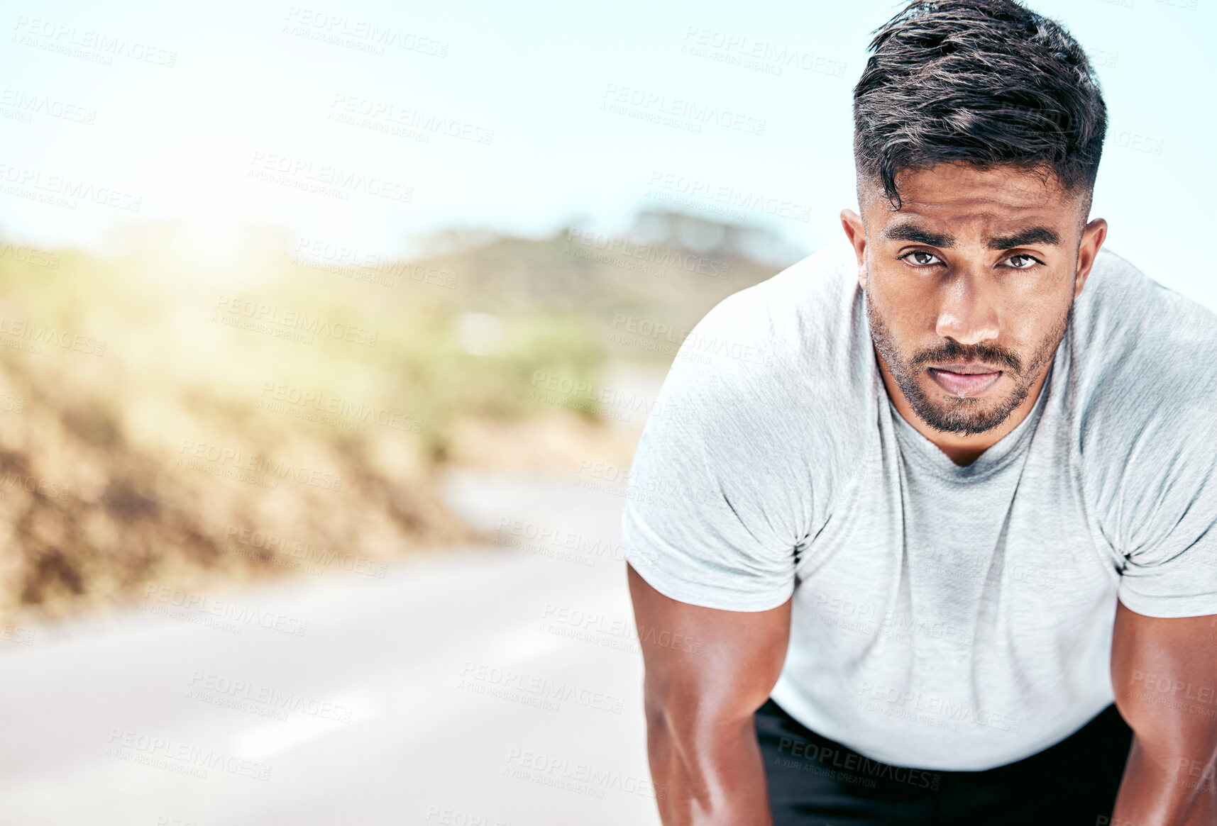 Buy stock photo Outdoor, man and tired on fitness break with running for wellness, wellbeing and health in India. Male person, portrait and sweat with jogging on road to exercise, training and workout for self care