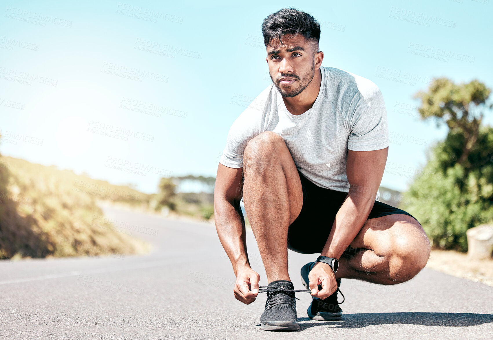 Buy stock photo Man, fitness and tying with shoes on road for running, exercise or cardio training in nature. Active male person or runner tie laces with sneakers on asphalt street in preparation for workout or race