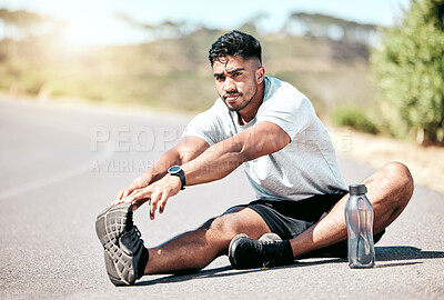 Buy stock photo Leg, stretching and portrait of man by mountain for fitness, workout and warm up on road in morning. Athlete, exercise and male person with flexibility for muscle, wellness and preparing for run