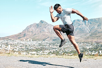 Buy stock photo Indian man, athlete and running for fitness on road for exercise, training and workout for race. Jump, motion and agile runner in outdoor practice for wellness, speed progress and health by mountain