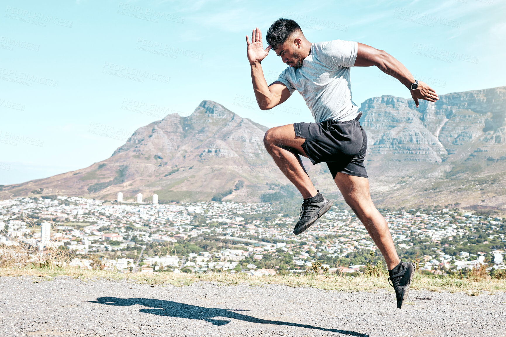 Buy stock photo Indian man, athlete and running for fitness on road for exercise, training and workout for race. Jump, motion and agile runner in outdoor practice for wellness, speed progress and health by mountain