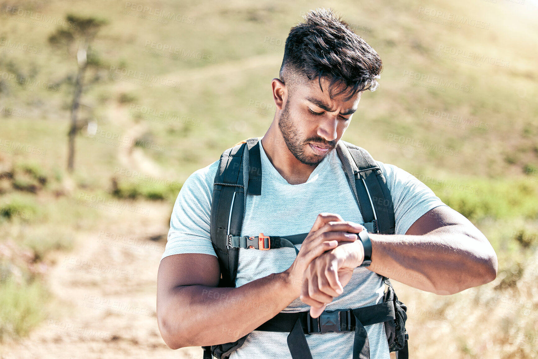 Buy stock photo Man, hike and checking digital watch with backpack for fitness, workout and hobby in countryside of Brazil. Male person, adventure and outdoor activity with tracking heart rate or distance on app