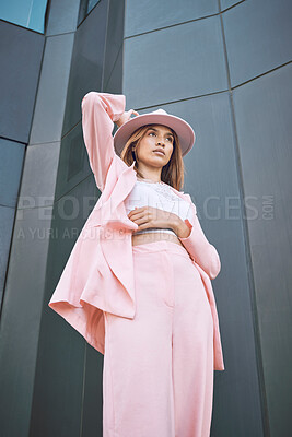 Buy stock photo Thinking, woman and fashion in city with confidence, attitude and designer clothing. Stylish, pink suit and hat by building for trendy outfit, urban downtown and gen z brand promotion on street