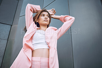 Buy stock photo Thinking, woman and fashion in city with attitude, confidence and designer clothing. Stylish, pink suit and person by building for trendy outfit, urban downtown and gen z brand promotion on street