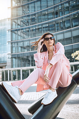 Buy stock photo Thinking, woman and fashion in city with sunglasses, attitude and designer clothing. Stylish, pink suit and accessories by building for trendy outfit, urban downtown and gen z promotion on street