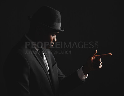 Buy stock photo Black man, finger gun and fashion suit in dark background for agent, elegant clothes and crime boss. Male person, thinking and formal outfit for secret spy, security and criminal danger in mafia