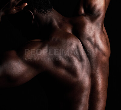 Buy stock photo Closeup, back muscle and black man with fitness, wellness and strength on dark studio background. Bodybuilder, person or model with training, workout and exercise with results, endurance or challenge