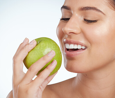 Buy stock photo Model, smile or woman with apple for healthy nutrition, skincare or snack on white background in studio. Food diet, fiber and face of girl eating fruit for detox and vitamin c for organic benefits