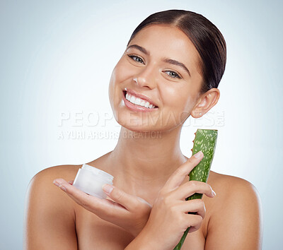 Buy stock photo Portrait, aloe vera and woman with cream, natural beauty and dermatology on gray studio background. Face, person or model with organic treatment, cosmetics or hydration with creme or smile with plant