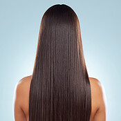 Rear view of a brunette woman with long lush beautiful hair posing ...