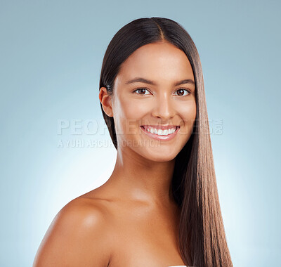 Buy stock photo Portrait, hair care and woman with smile, shine and dermatology on blue studio background. Face, person and model with shampoo, texture and volume with grooming routine, natural beauty and cosmetics