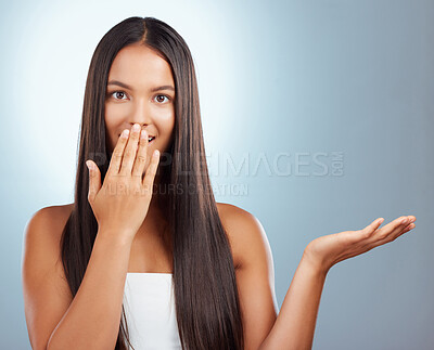 Buy stock photo Hair care, wow and portrait of woman in studio with presentation, hairstyle and secret treatment in salon. Keratin, straight haircut and shocked face of girl on blue background with product placement