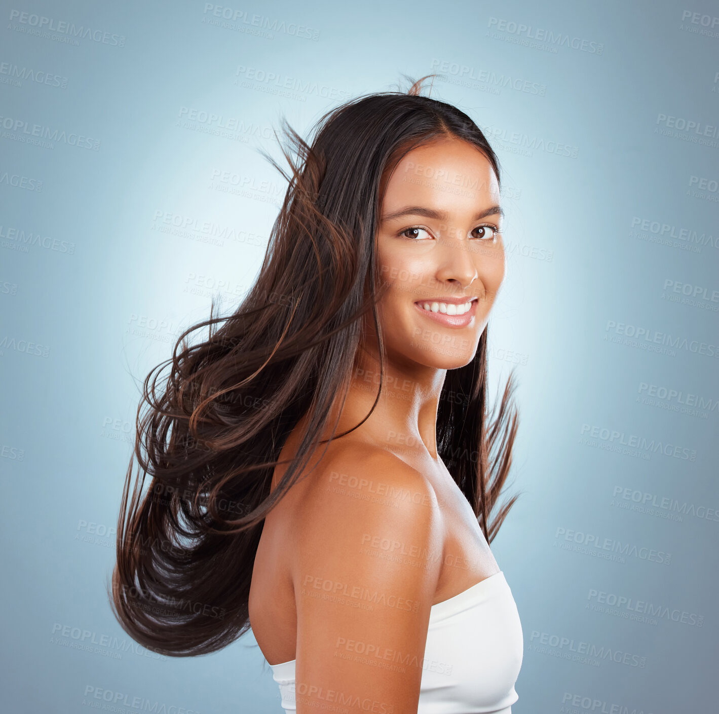 Buy stock photo Happy woman, wind and hairstyle in studio portrait, texture treatment and strong hair on blue background. Female person, healthy growth and cosmetics shampoo or conditioner, confidence and breeze