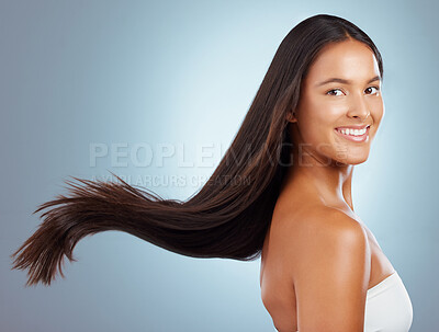 Buy stock photo Happy woman, breeze and hair care in studio portrait, keratin treatment and smooth on blue background. Female person, growth and cosmetics shampoo or conditioner for healthy scalp, clean and wind