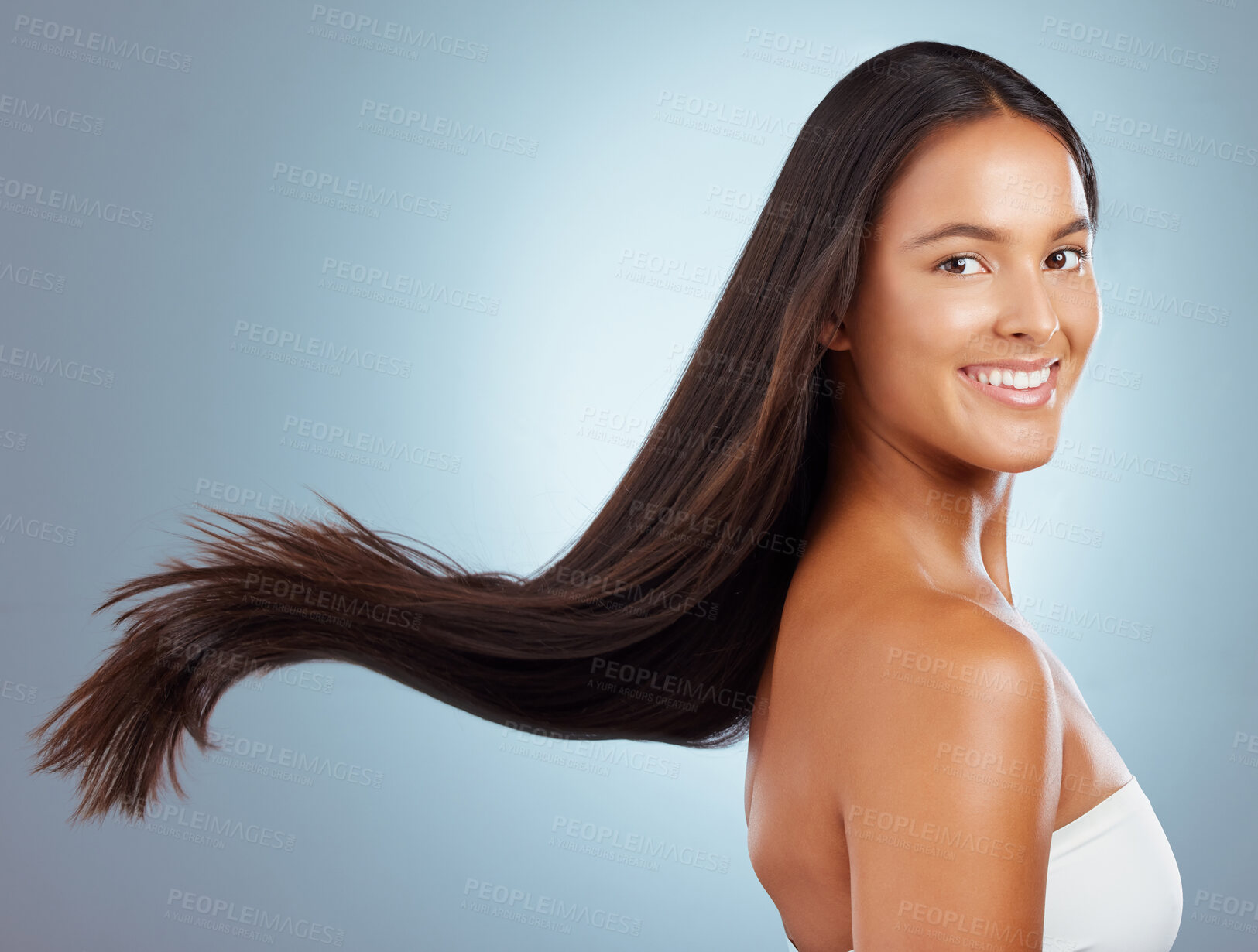 Buy stock photo Happy woman, breeze and hair care in studio portrait, keratin treatment and smooth on blue background. Female person, growth and cosmetics shampoo or conditioner for healthy scalp, clean and wind