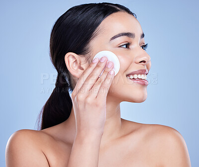 Buy stock photo Cotton pad, skincare and woman in studio with natural, health and facial routine for hygiene. Beauty, glow and female person with face dermatology treatment with cosmetic product by blue background.