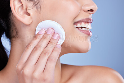 Buy stock photo Cotton pad, skincare and face of woman in studio with natural, health and facial routine for hygiene. Beauty, glow and person with dermatology treatment with cosmetic product by blue background.