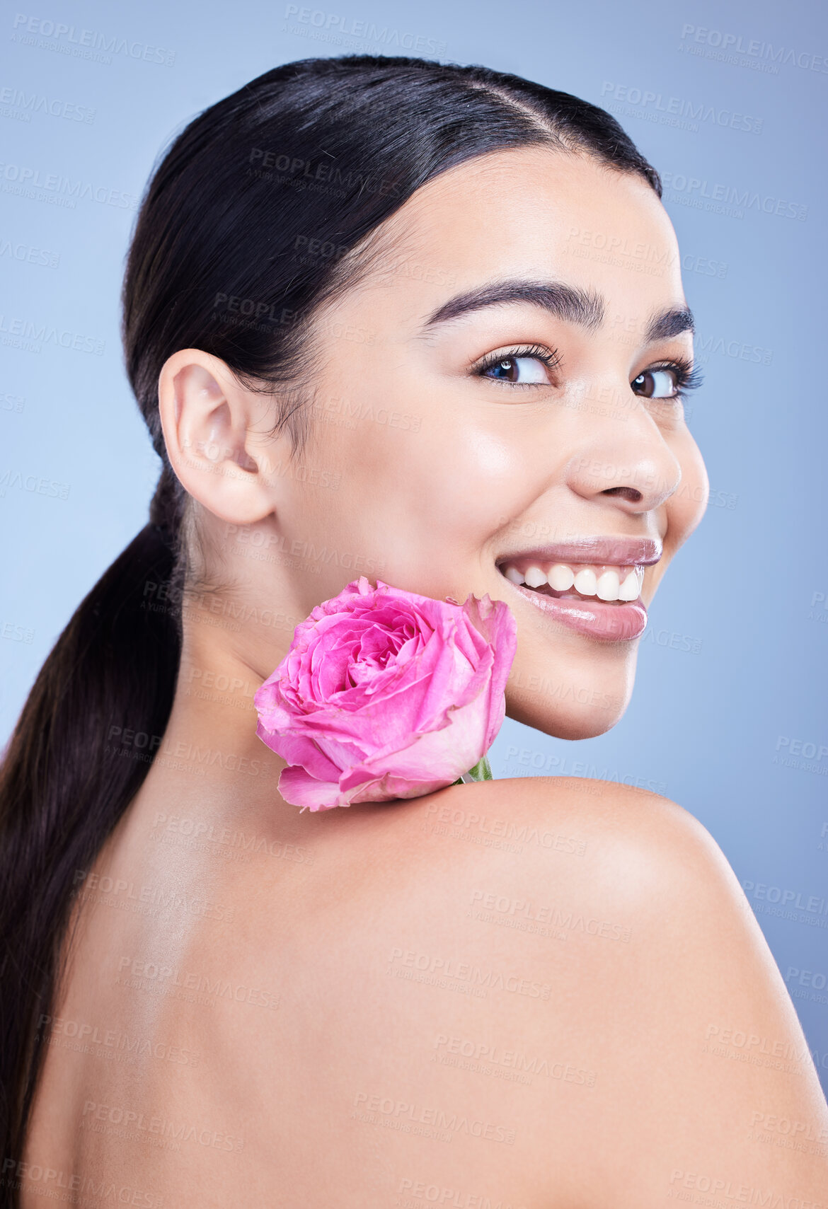 Buy stock photo Portrait, rose or woman with smile or natural beauty on blue background with flower and glow. Face, happy or girl model in studio with floral cosmetics, plants or skincare for facial results