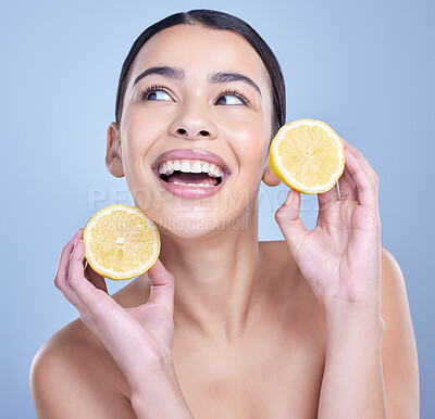 Buy stock photo Girl, lemon and thinking in studio for skincare, organic and natural cosmetic with citrus acid or vitamin c. Woman, happy and fruit on blue background for healthy glow, detox or oil control treatment