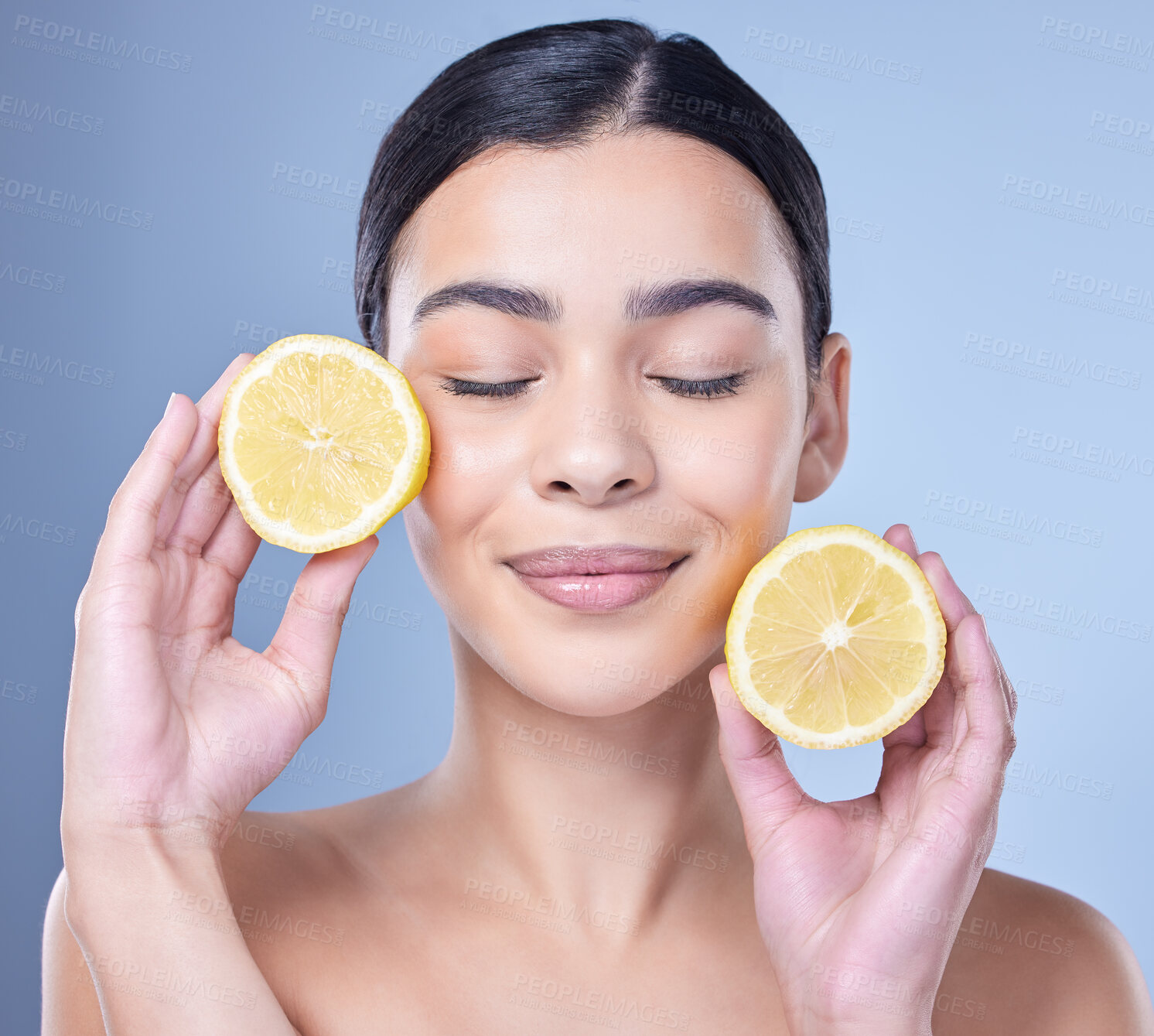 Buy stock photo Girl, lemon and calm in studio for skincare, organic or natural cosmetic with citrus acid or vitamin c. Woman, eyes closed or fruit on blue background for healthy glow, detox or oil control treatment