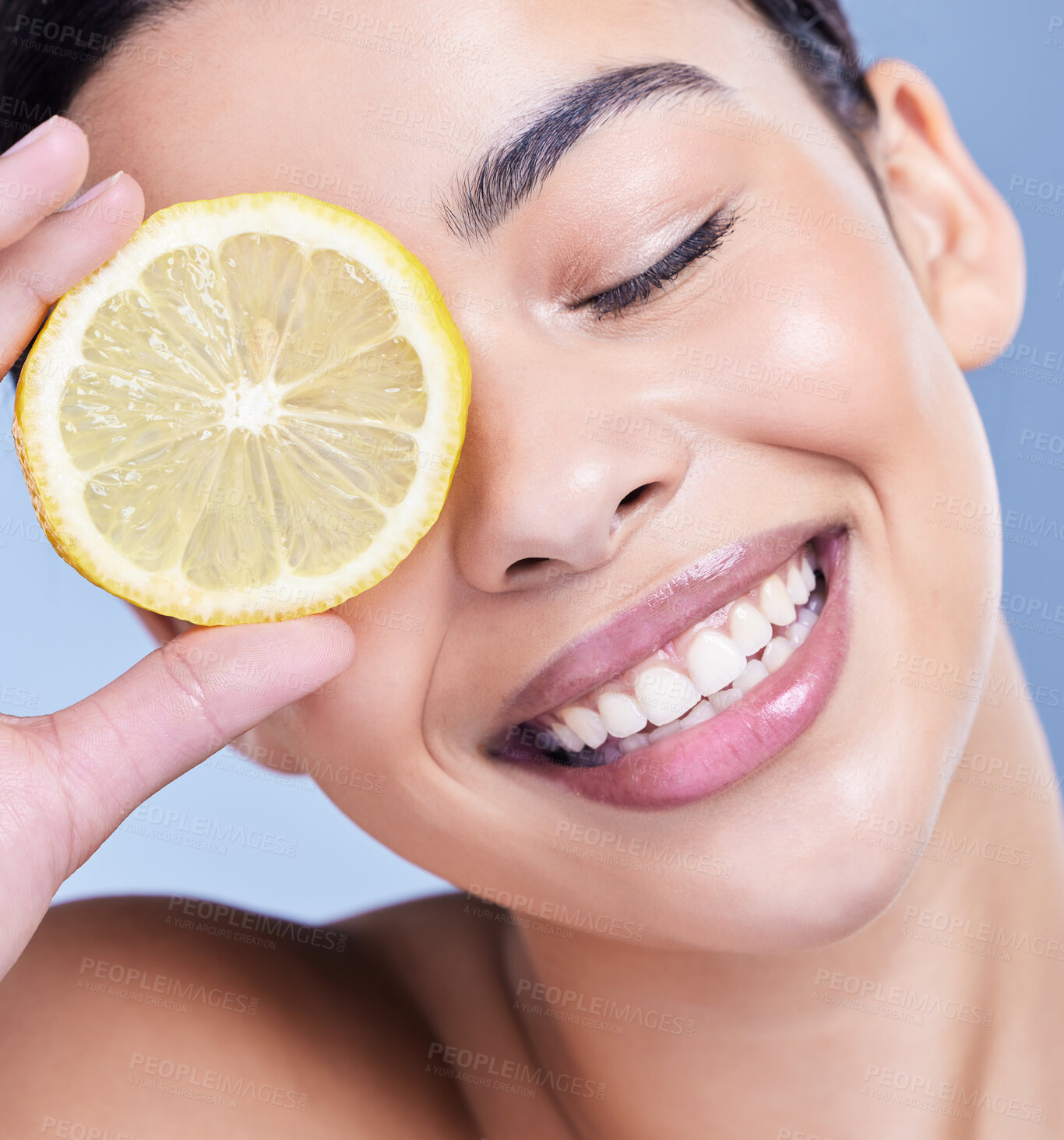 Buy stock photo Skincare, smile and woman with lemon for beauty, health benefits and nutrition by blue studio background. Face, closeup and model with organic fruit for detox, natural and vitamin c with eyes closed
