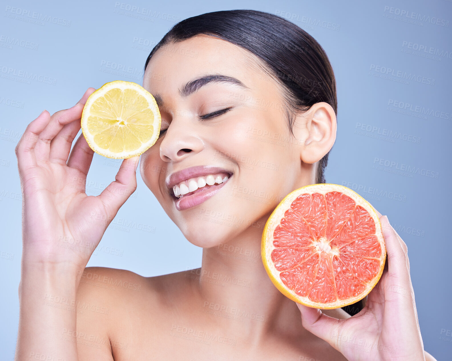 Buy stock photo Beauty, skincare and happy woman with grapefruit or lemon by blue studio background. Face, cosmetic or model with organic fruits for healthy diet, natural nutrition or detox benefits with eyes closed