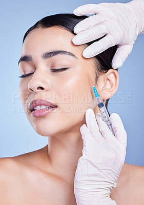 Buy stock photo Woman, hands and eyes closed for facelift with needle in studio on blue background for grooming and beauty. Female person, aesthetics and portrait with cosmetics for skincare, filler and anti aging