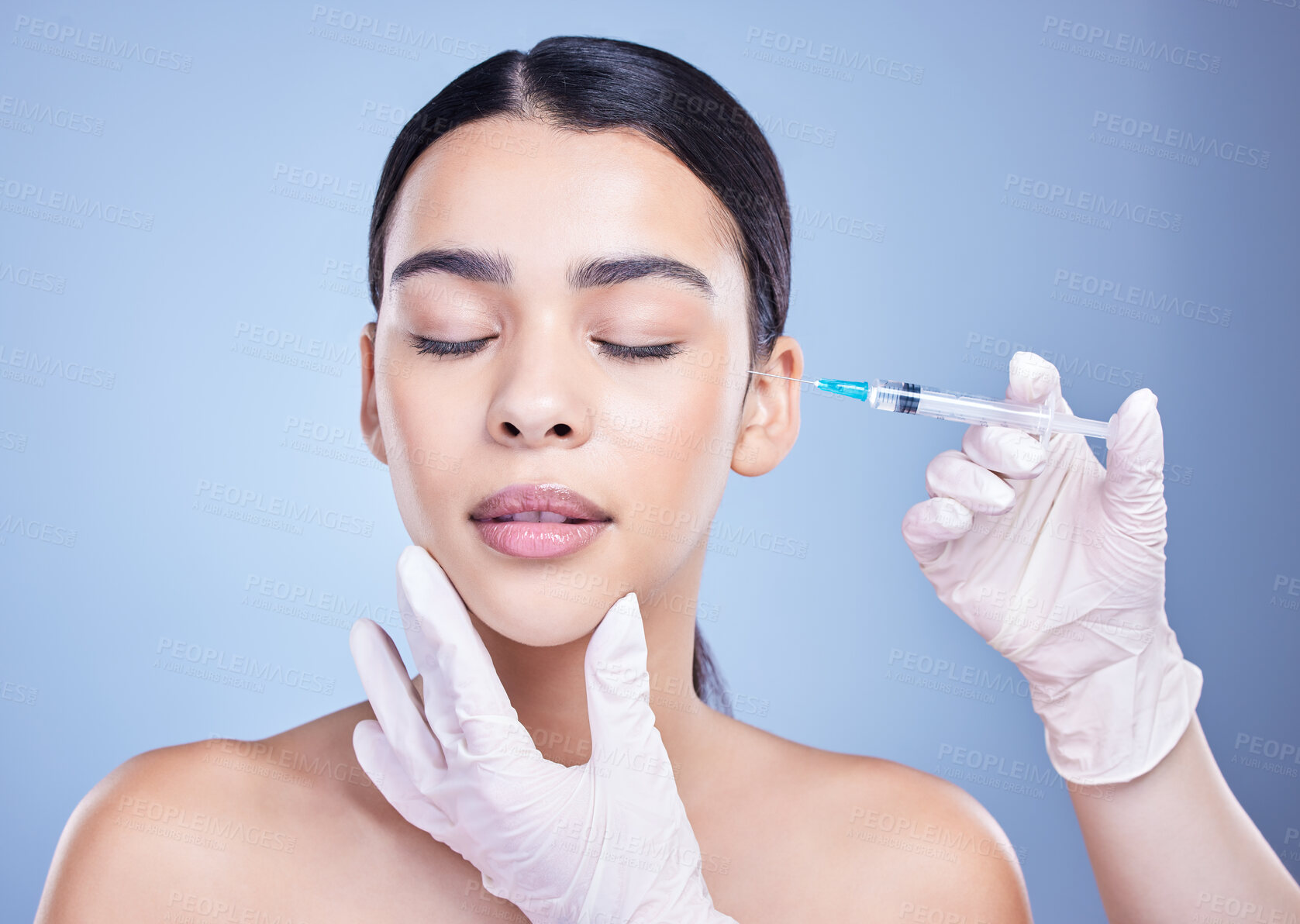 Buy stock photo Woman, hands and eyes closed for facelift with injection in studio on blue background for grooming and beauty. Female person, aesthetics and needle with cosmetics for skincare, fillers and anti aging