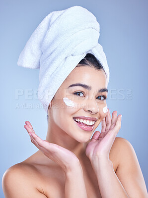 Buy stock photo Portrait, woman and cosmetics with beauty, cream and dermatology on blue studio background. Happy person, face and model with towel, grooming routine and creme with treatment, wellness and soft skin