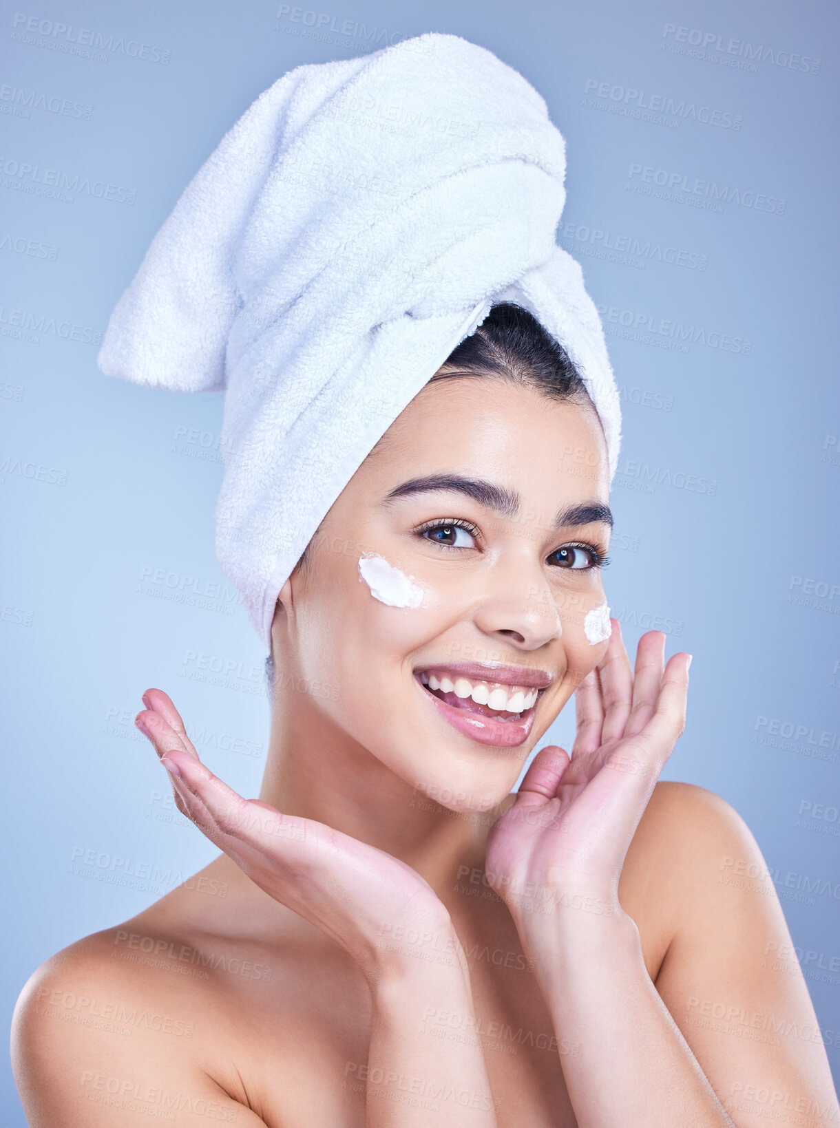 Buy stock photo Portrait, woman and cosmetics with beauty, cream and dermatology on blue studio background. Happy person, face and model with towel, grooming routine and creme with treatment, wellness and soft skin