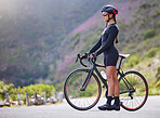 Beautiful, athletic, mixed race young woman exercising outside in the forest. Healthy and sporty female athlete out for a cycle in the wilderness. Endurance and cardio during a workout in the woods