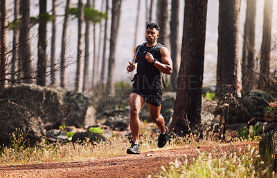 Buy stock photo Running, man and serious with fitness in forest for healthy body, cardio or exercise in morning. Athlete, person and trees with workout in nature for sports, wellness or training for weekend marathon