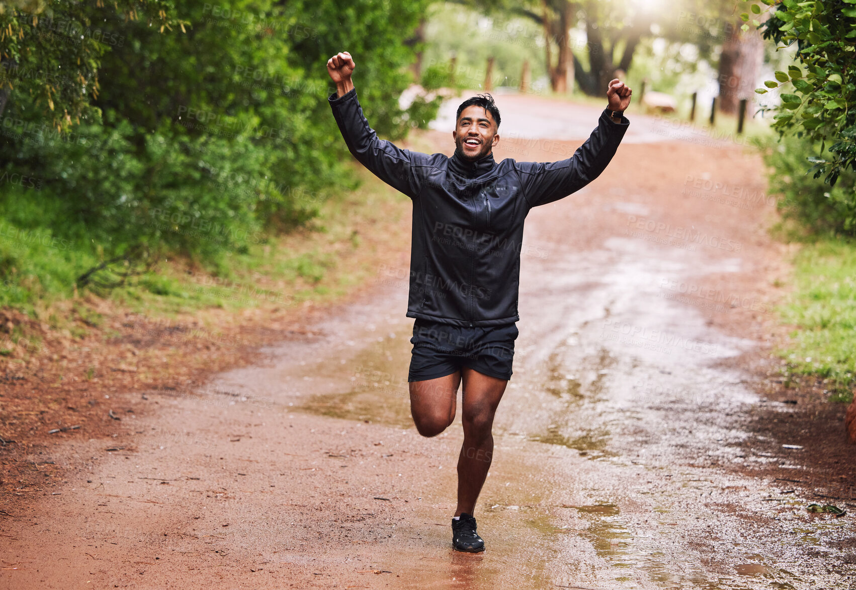 Buy stock photo Celebrate, sports and man in nature for running, marathon training and exercise goals outdoors. Fitness, mountain and happy person with hands up for success for performance, victory and wellness