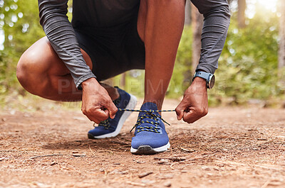 Buy stock photo Tying, shoelaces and hands of runner, outdoor and workout in woods, legs and athlete in nature for running. Feet, hiking and person in forest for exercise, walk and training for competition in USA