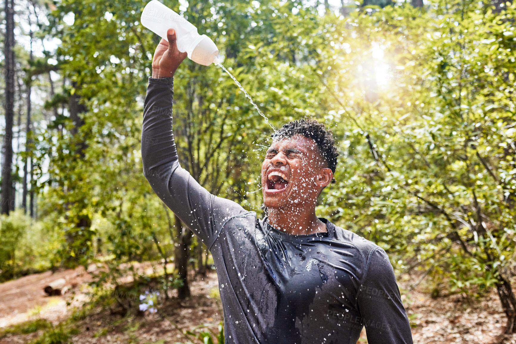 Buy stock photo Water, athlete and bottle of runner in woods with break and cool down from extreme training and exercise. Forest, sport and tired and hot man in a park ready for wellness, health and mountain workout