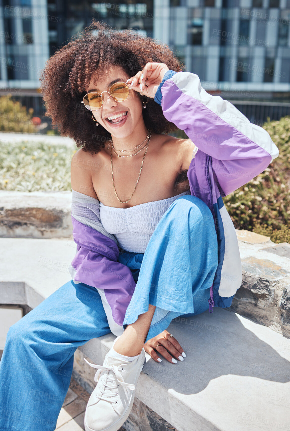 Buy stock photo Woman, portrait and cool in outdoor for fashion, stylish and smile with confidence in Spain. City, female person and curly hair with trendy sunglasses on vacation, holiday and pride for accessory