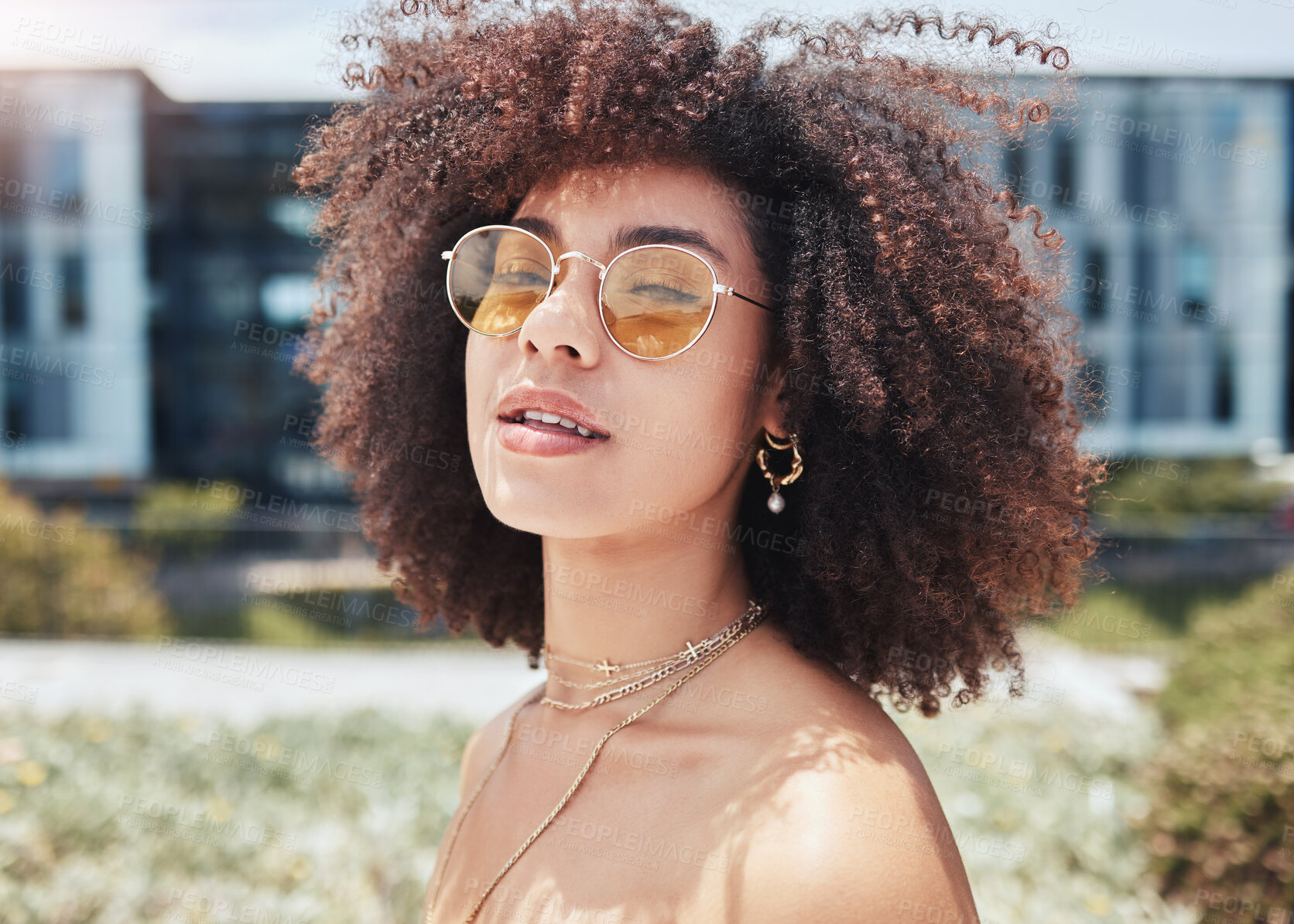 Buy stock photo Woman, portrait and accessory in city for fashion, stylish and confident with smile in Spain. Outdoor, female person and curly hair with trendy sunglasses on vacation, holiday and pride for cool look