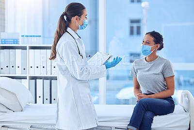 Buy stock photo Healthcare, woman and doctor with clipboard in consultation, hospital or clinic checkup. Face mask, document and patient with medical professional for pandemic protection for covid compliance or care